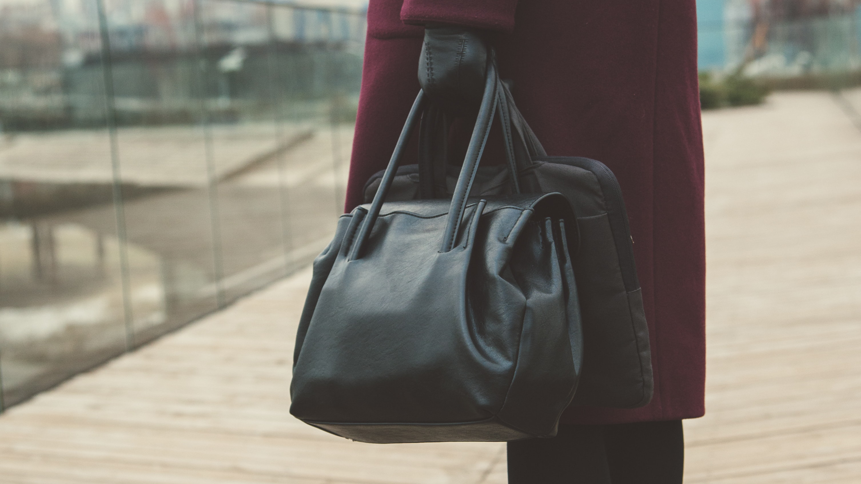 woman holding a handbag and laptop case