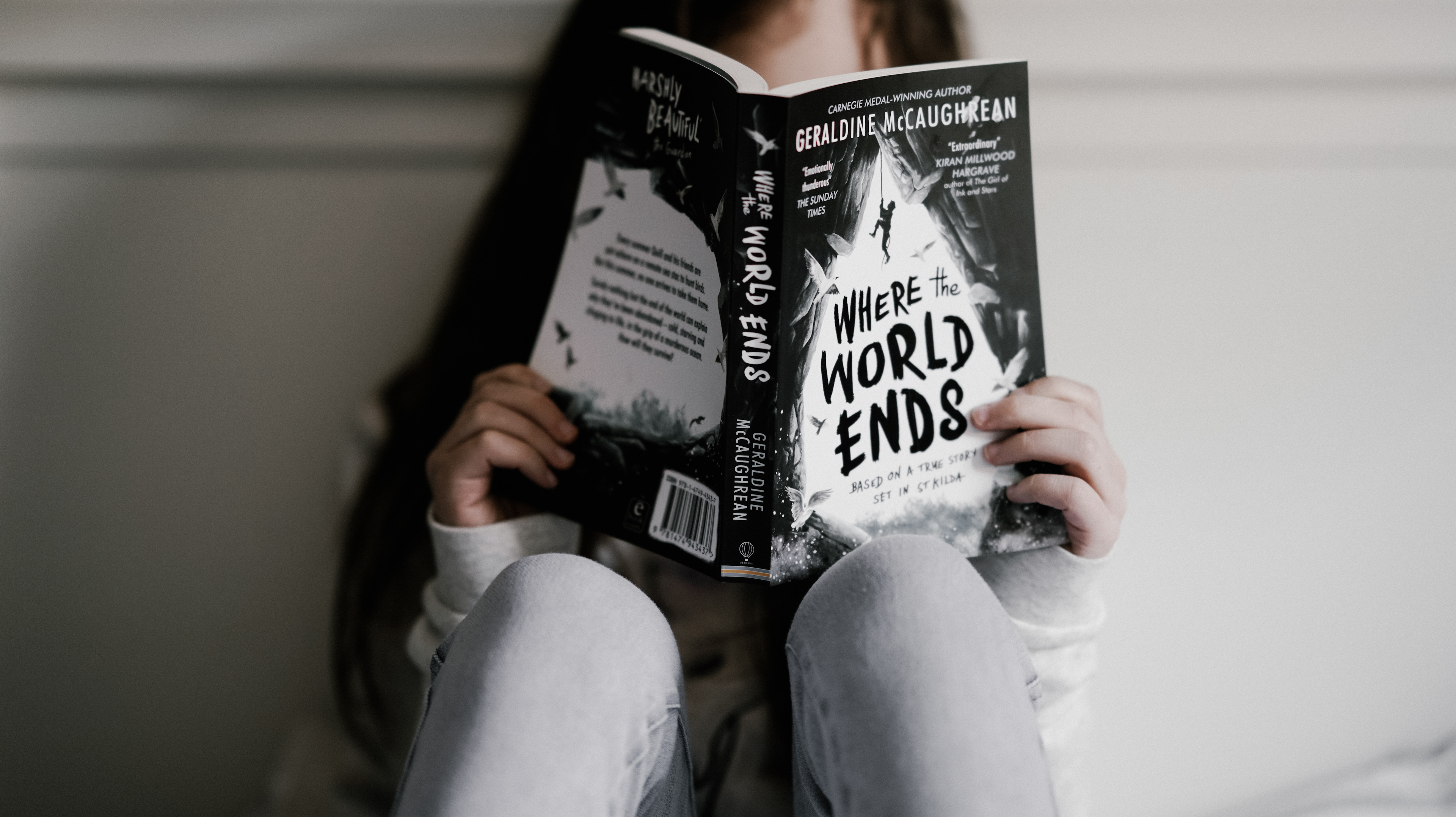 girl reading where the world ends